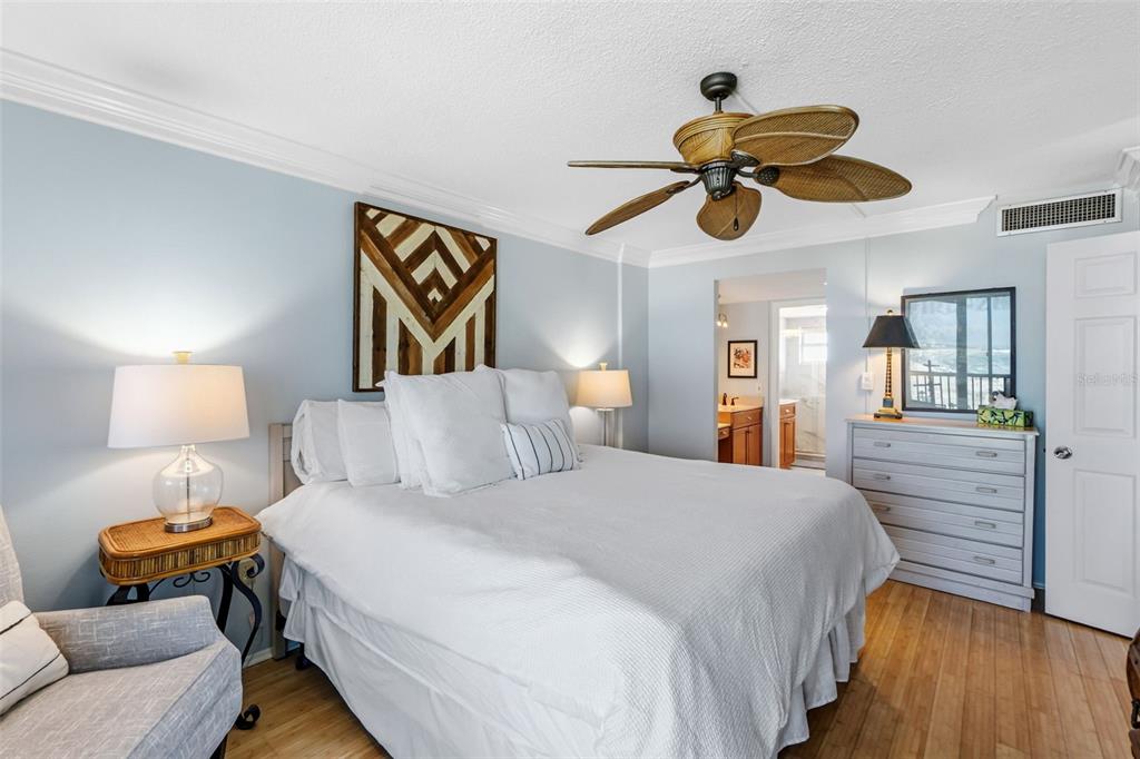 6300 Midnight Pass Road, Unit 708 Sarasota, FL 34242 - Photo 30 of 49 a bedroom with a bed and wooden floor