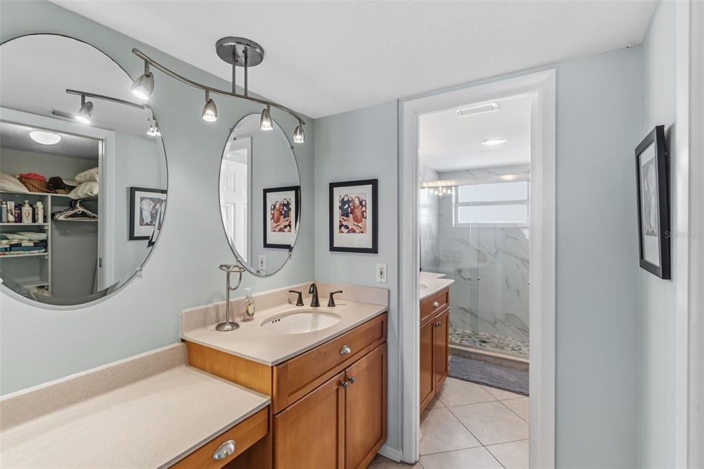 6300 Midnight Pass Road, Unit 708 Sarasota, FL 34242 - Photo 31 of 49 a bathroom with a sink a mirror and a shower