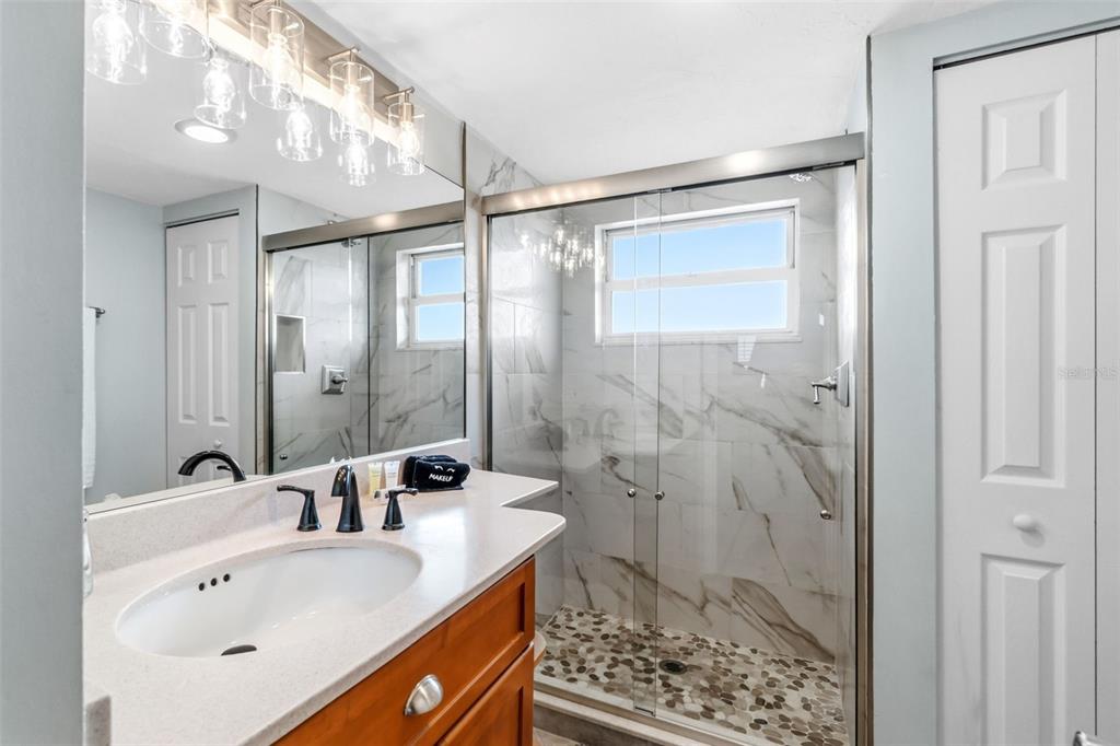 6300 Midnight Pass Road, Unit 708 Sarasota, FL 34242 - Photo 33 of 49 a bathroom with a granite countertop sink mirror and shower
