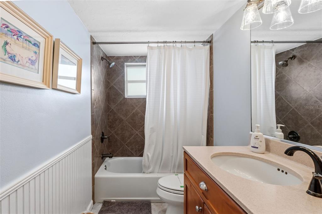 6300 Midnight Pass Road, Unit 708 Sarasota, FL 34242 - Photo 35 of 49 a bathroom with a sink toilet and shower