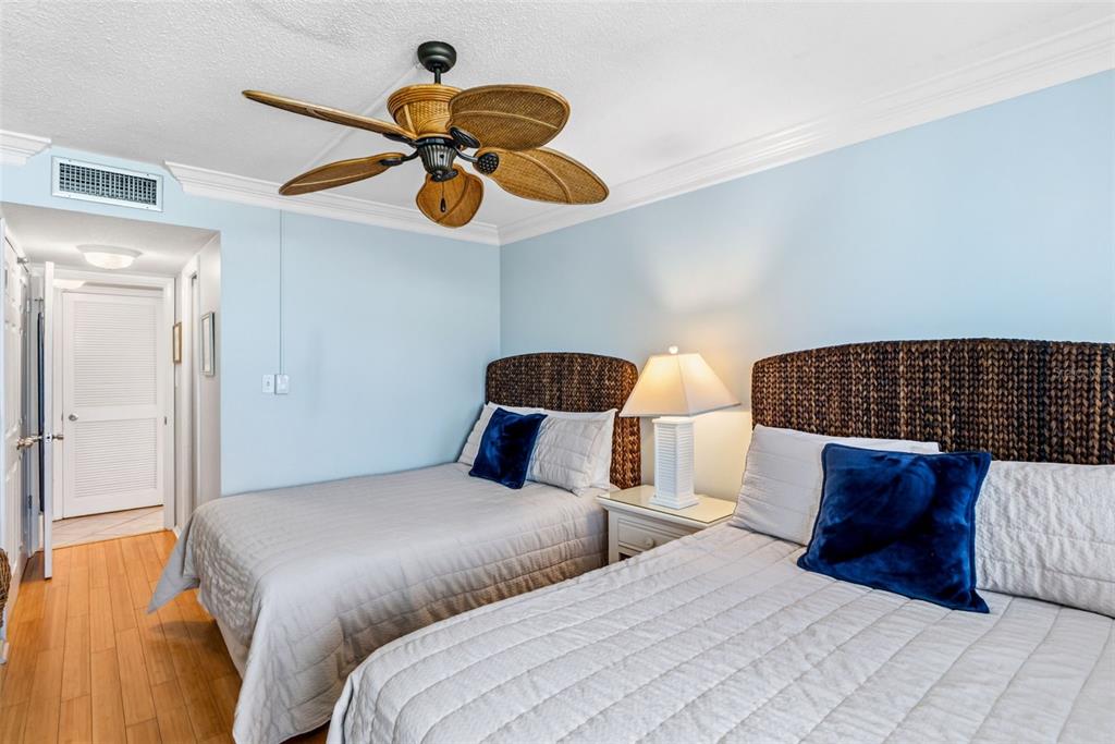 6300 Midnight Pass Road, Unit 708 Sarasota, FL 34242 - Photo 39 of 49 a bedroom with bed and a chandelier