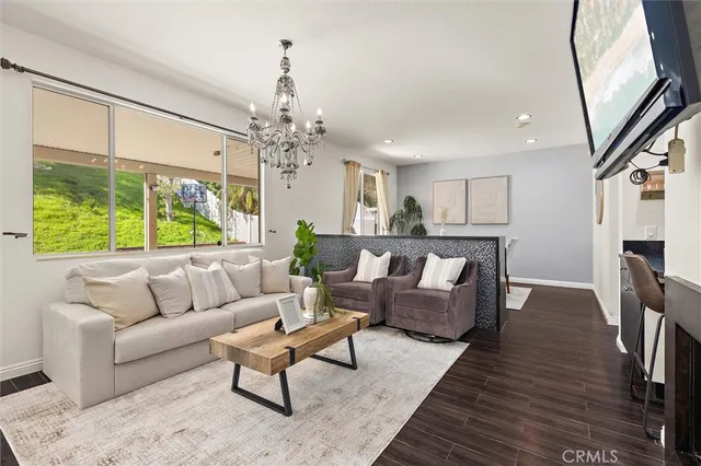 a living room with furniture and a chandelier