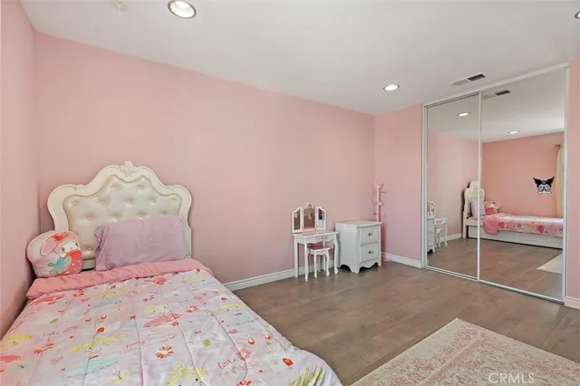 a bedroom with a bed and a chair