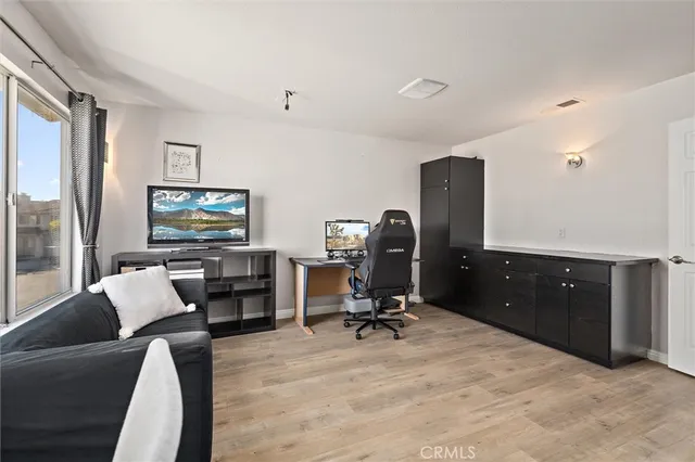 a view of a livingroom with workspace and a window