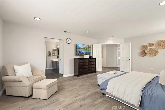 a spacious bedroom with a bed and couch