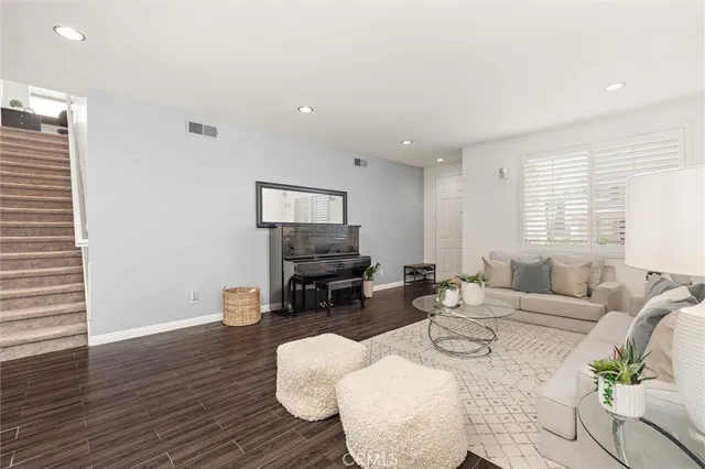 a living room with furniture a dining table and a window