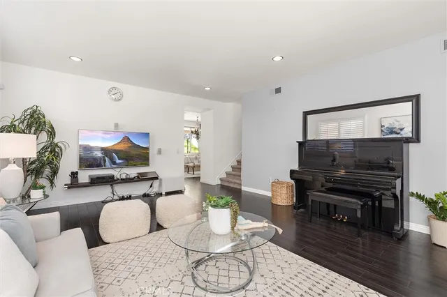 a living room with furniture and wooden floor