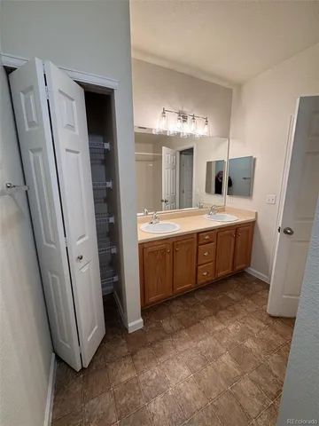 a room with a sink and a large mirror