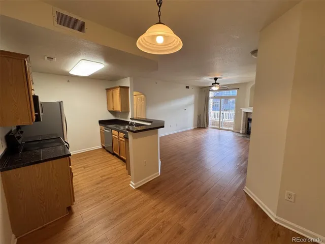 a kitchen with granite countertop a stove top oven a sink and dishwasher