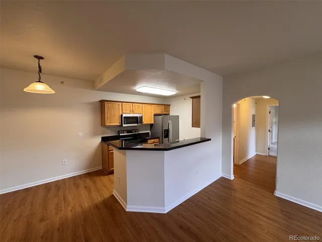 a kitchen with stainless steel appliances granite countertop a stove and a sink