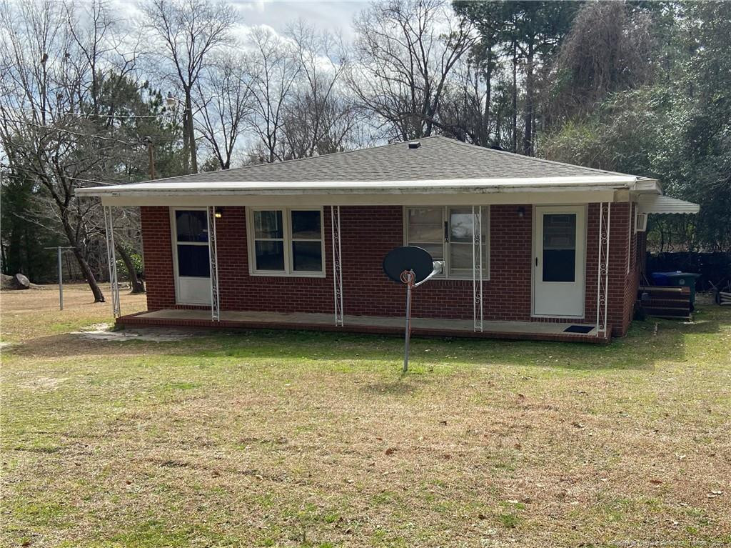 a backyard of a house with barbeque oven and table