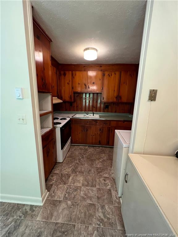 116 Oates Drive, Unit A Fayetteville, NC 28311 - Photo 5 of 9 a kitchen with wooden cabinets and a sink