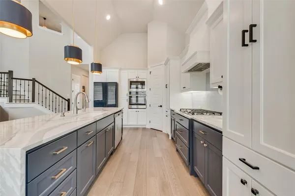 a kitchen with counter top space and wooden floor