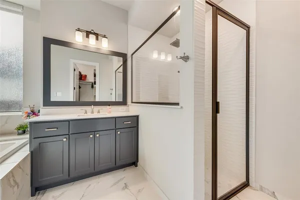 a bathroom with a tub sink and mirror