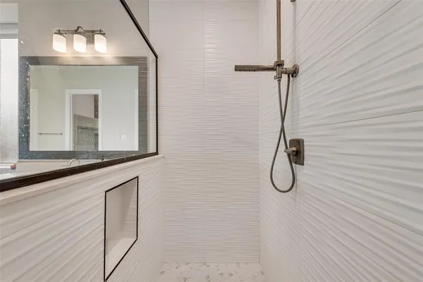 a bathroom with a mirror sink and vanity