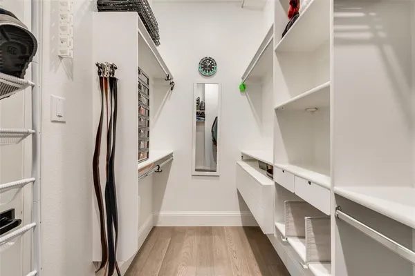 a view of a hallway view with staircase and kitchen view