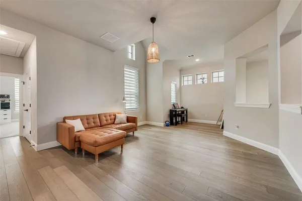 a living room with furniture and a wooden floor