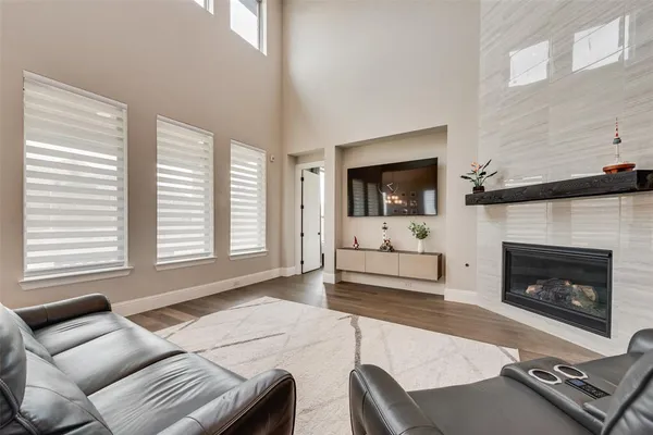 a living room with furniture fireplace and flat screen tv