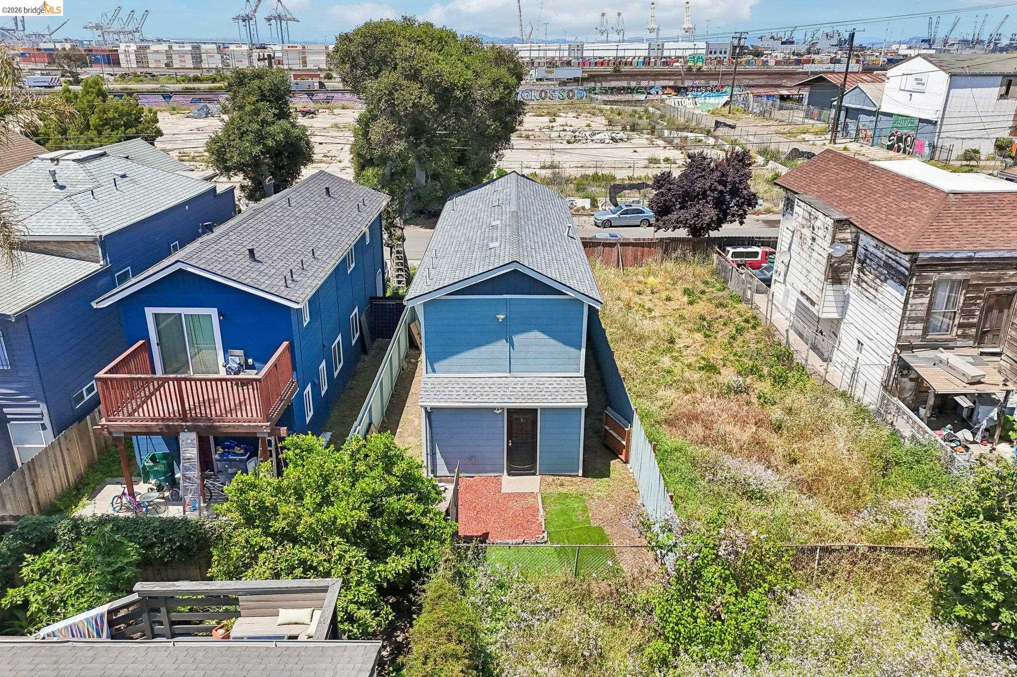 874 Pine Street Oakland, CA 94607 - Photo 35 of 39 Two-story residence featuring a blue exterior, a gabled roof, and a ground-level garage