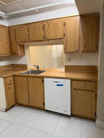 a kitchen with cabinets a sink and a stove