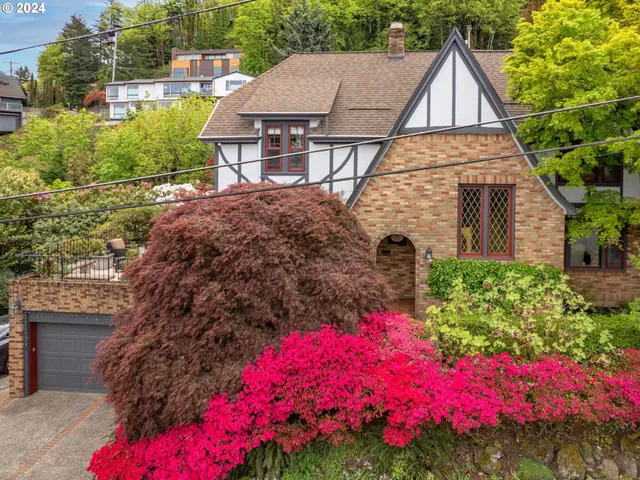 a view of a house with a yard and garden