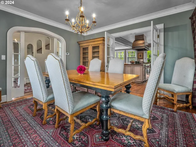 a dining room with furniture a rug and wooden floor
