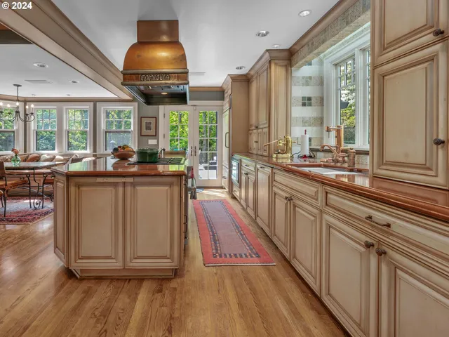 a kitchen with stainless steel appliances granite countertop a stove and a wooden floors