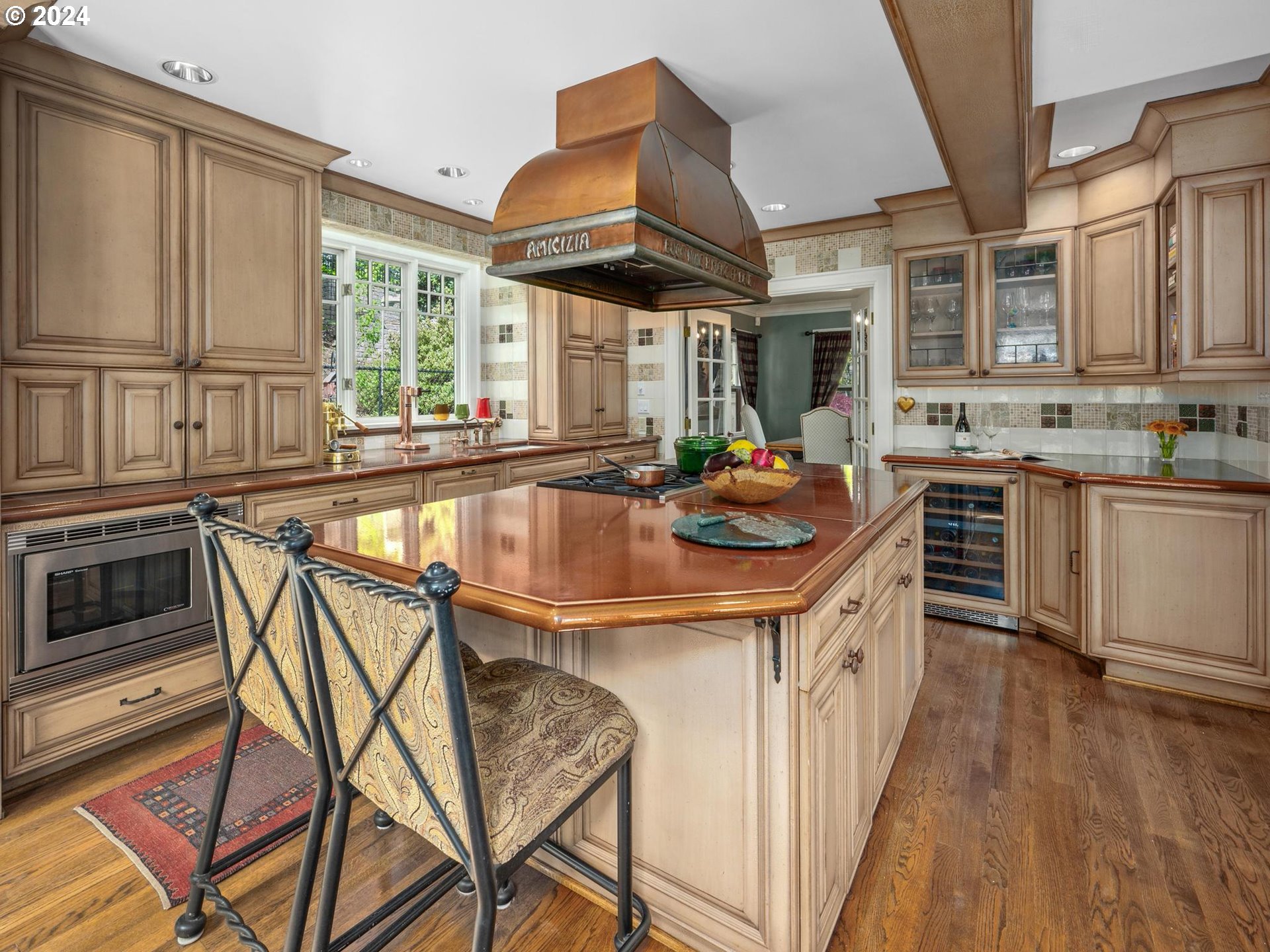 758 Northwest Powhatan Terrace Portland, OR 97210 - Photo 17 of 48 a kitchen with stainless steel appliances granite countertop a stove a sink dishwasher and cabinets with wooden floor