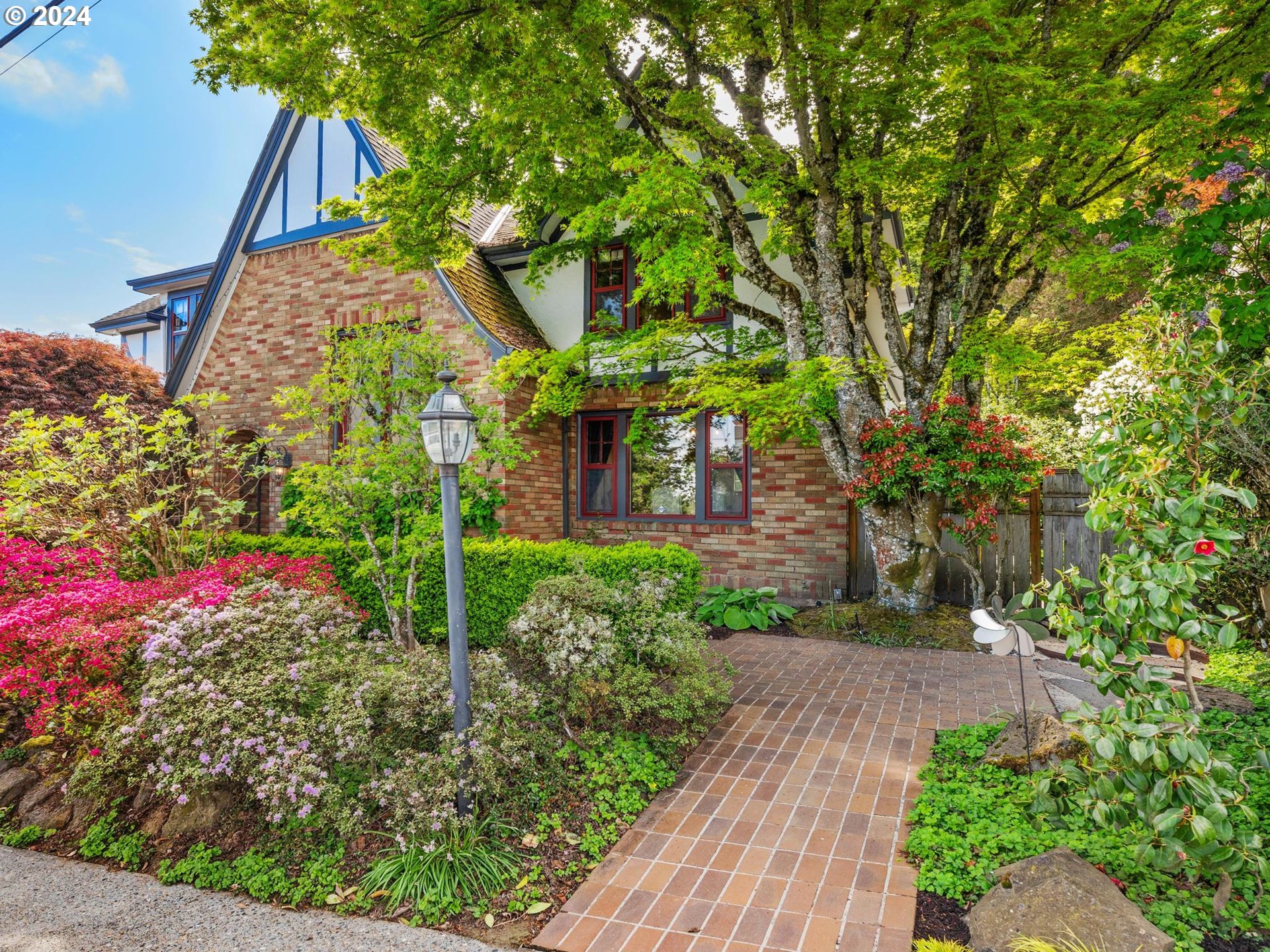 758 Northwest Powhatan Terrace Portland, OR 97210 - Photo 3 of 48 a view of a garden with flowers and trees