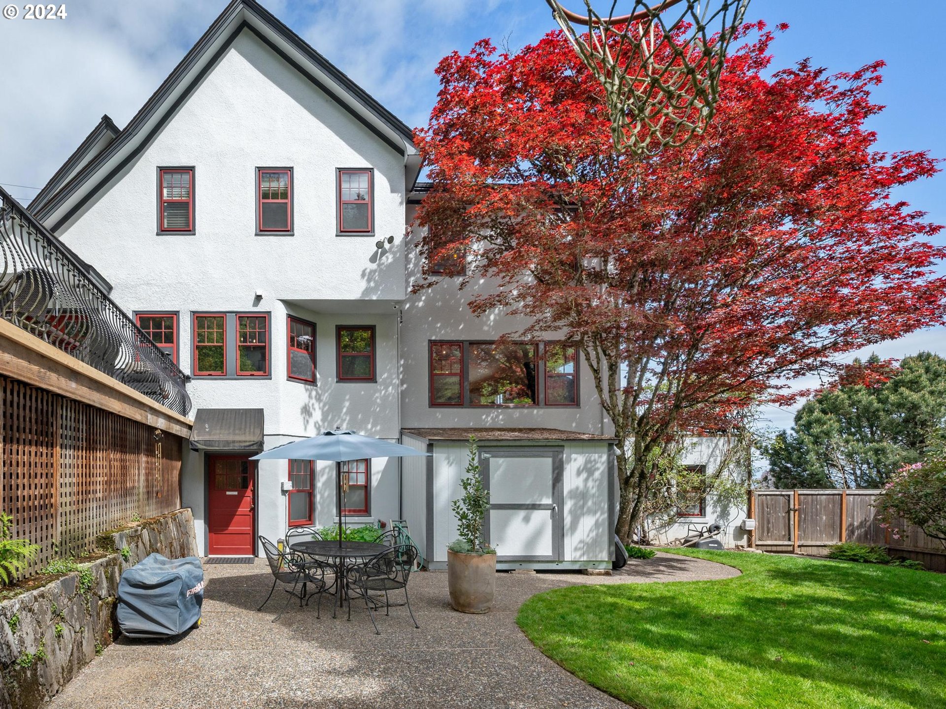 758 Northwest Powhatan Terrace Portland, OR 97210 - Photo 43 of 48 a view of a white house next to a yard with big trees