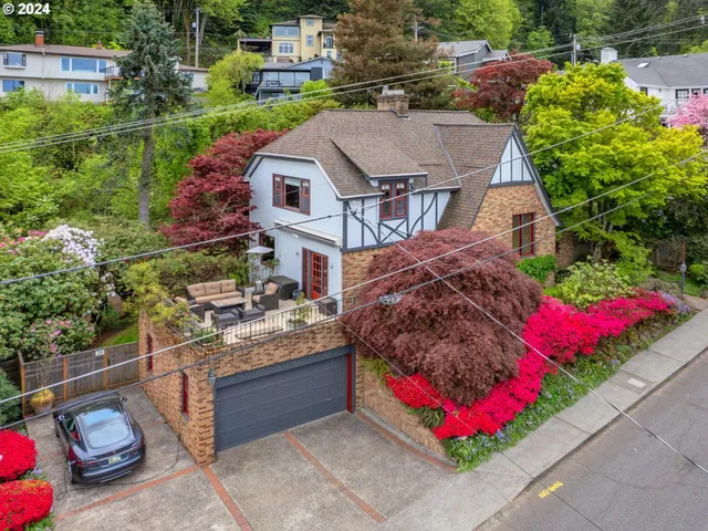 a view of a house with a yard and garden