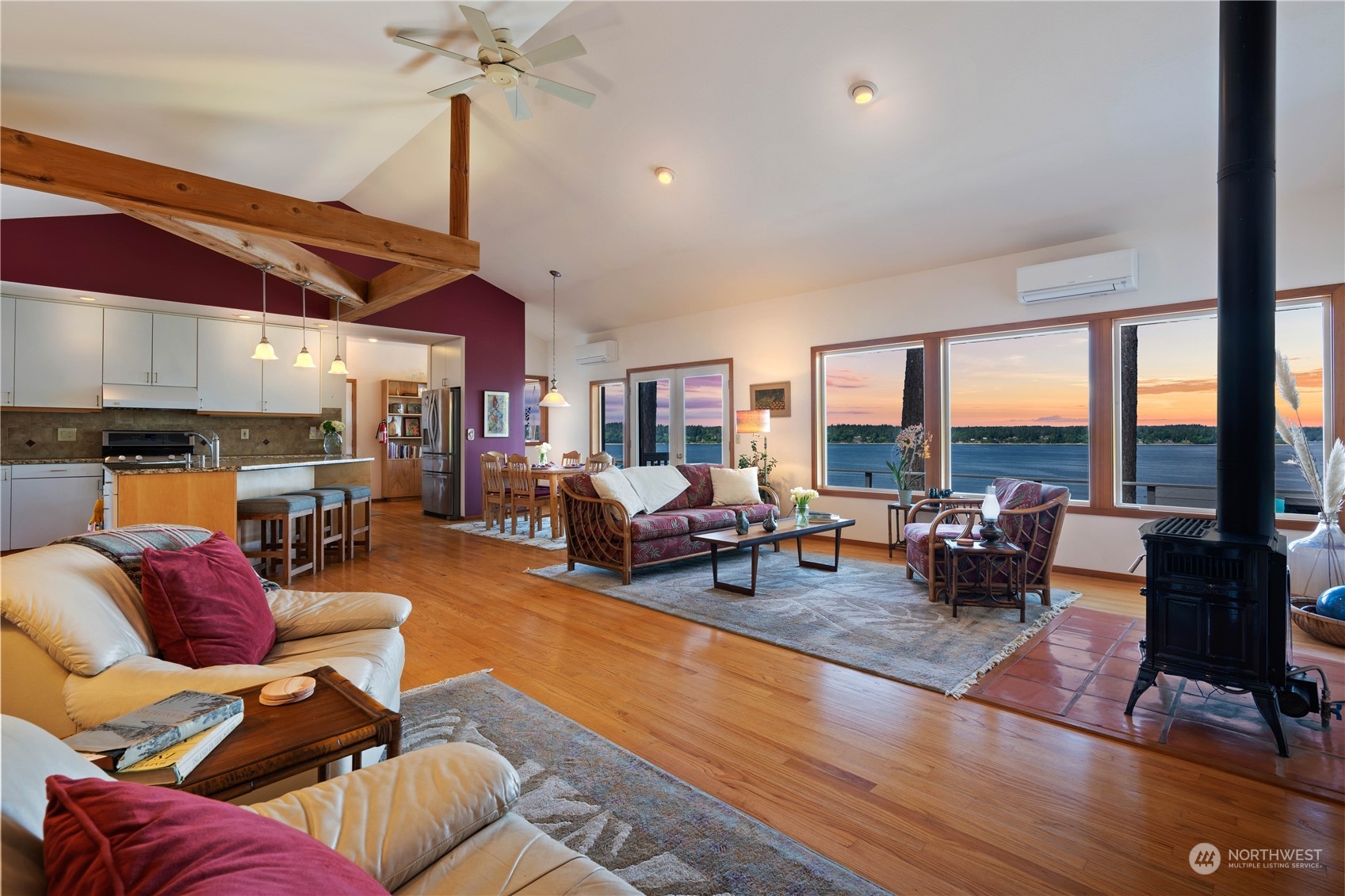8615 Higgins Cove Road Anderson Island, WA 98303 - Photo 12 of 40 a living room with furniture fireplace and a large window