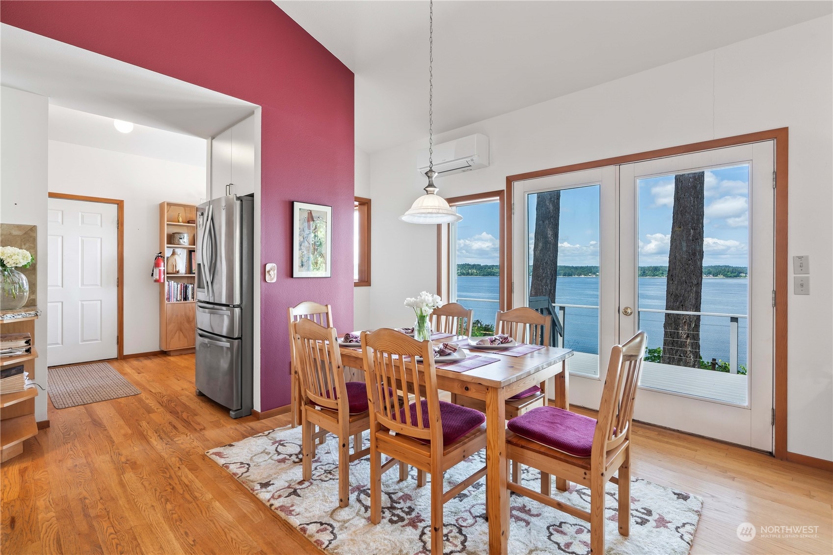 8615 Higgins Cove Road Anderson Island, WA 98303 - Photo 16 of 40 a view of a dining room with furniture and wooden floor