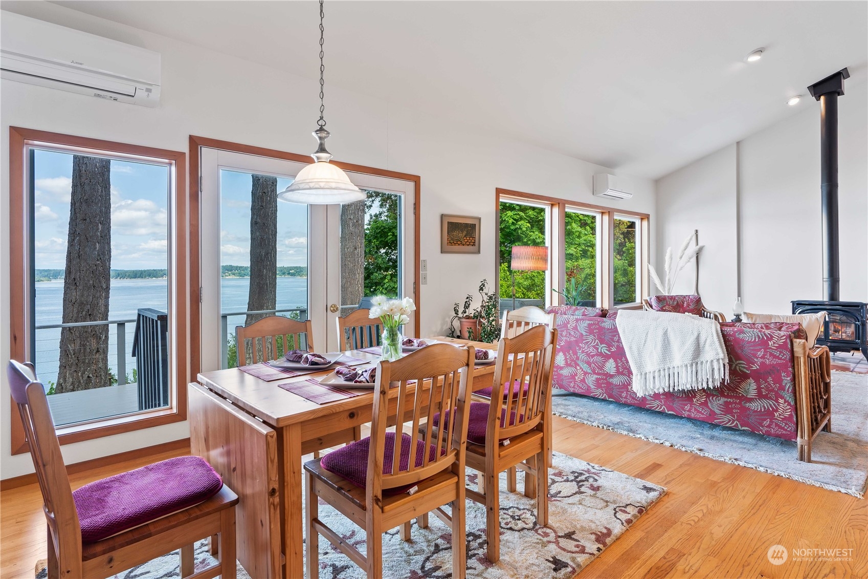 8615 Higgins Cove Road Anderson Island, WA 98303 - Photo 17 of 40 a living room with furniture a large window and wooden floor