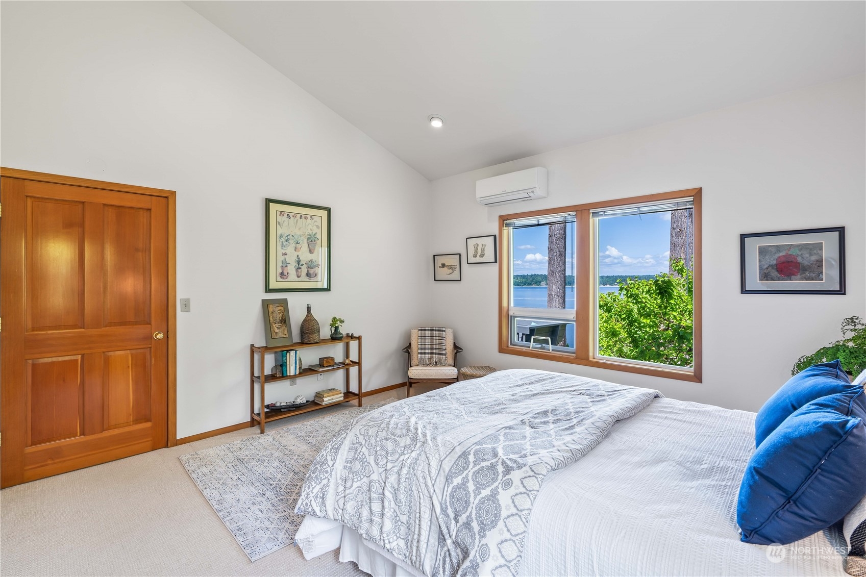 8615 Higgins Cove Road Anderson Island, WA 98303 - Photo 22 of 40 a bedroom with a large bed and a window