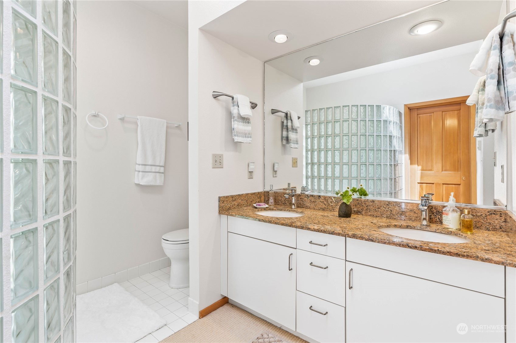 8615 Higgins Cove Road Anderson Island, WA 98303 - Photo 23 of 40 a bathroom with a granite countertop sink toilet and shower