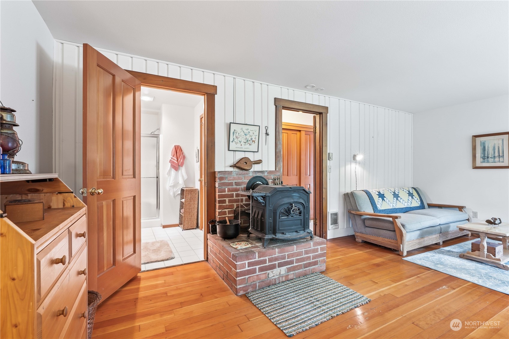 8615 Higgins Cove Road Anderson Island, WA 98303 - Photo 24 of 40 a bedroom with furniture and a fireplace