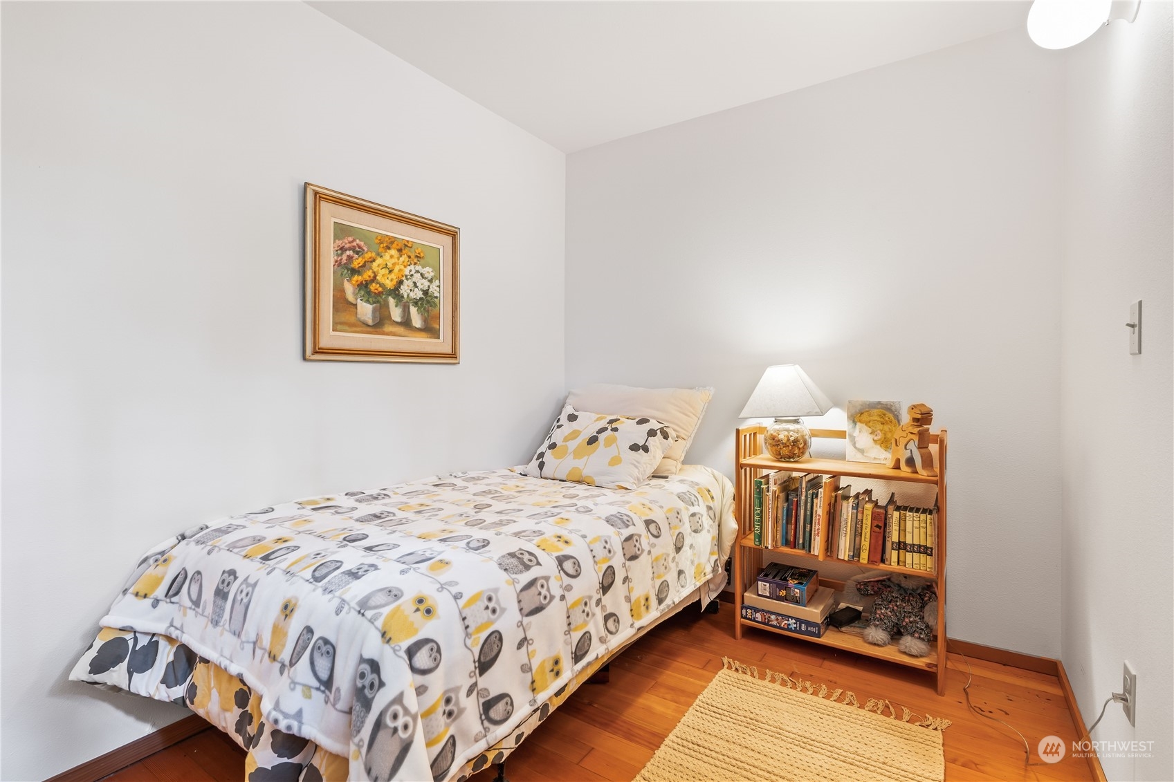 8615 Higgins Cove Road Anderson Island, WA 98303 - Photo 26 of 40 a bedroom with a bed and dresser
