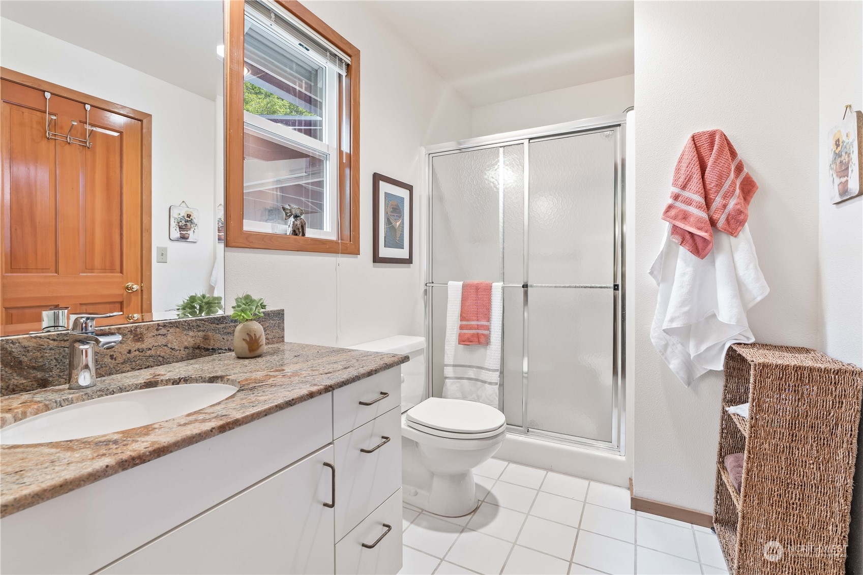 8615 Higgins Cove Road Anderson Island, WA 98303 - Photo 27 of 40 a bathroom with a granite countertop sink toilet and shower