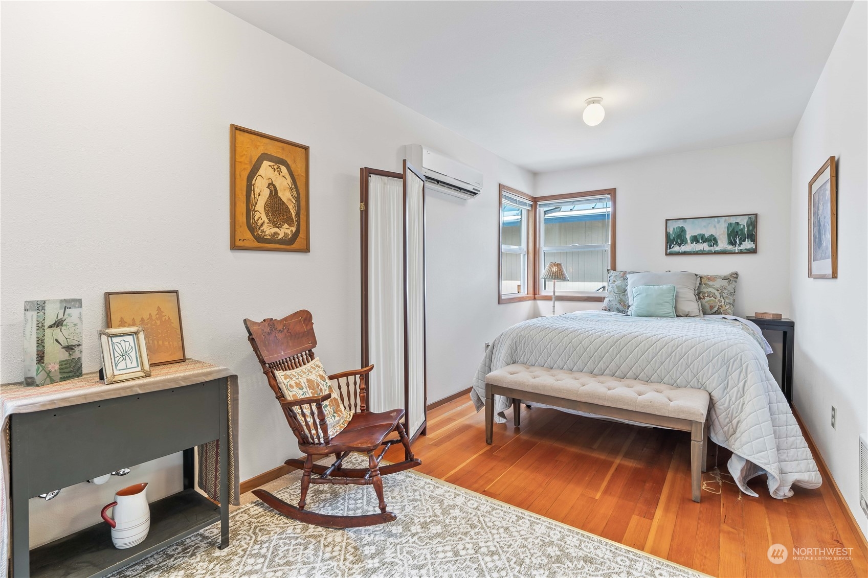 8615 Higgins Cove Road Anderson Island, WA 98303 - Photo 28 of 40 a bedroom with a bed a chair and painting on the wall