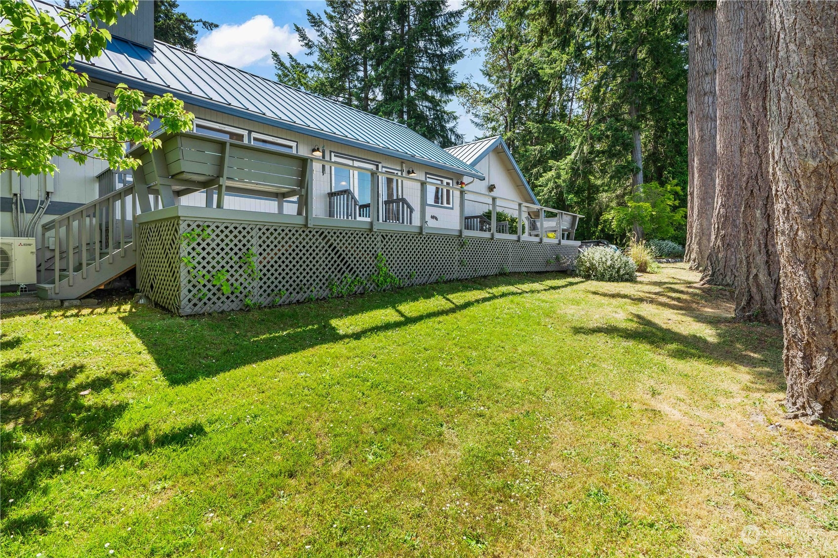 8615 Higgins Cove Road Anderson Island, WA 98303 - Photo 31 of 40 a view of a house with a yard