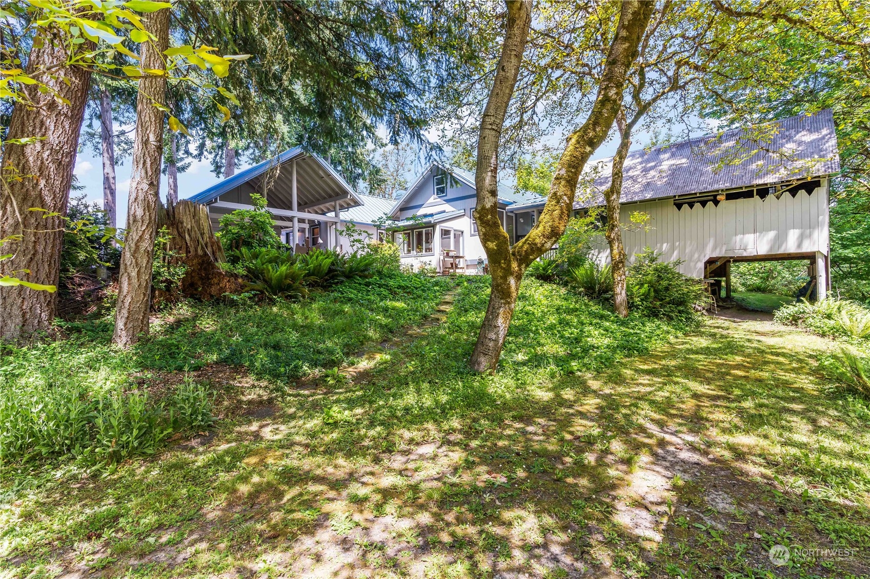 8615 Higgins Cove Road Anderson Island, WA 98303 - Photo 37 of 40 a front view of a house with garden