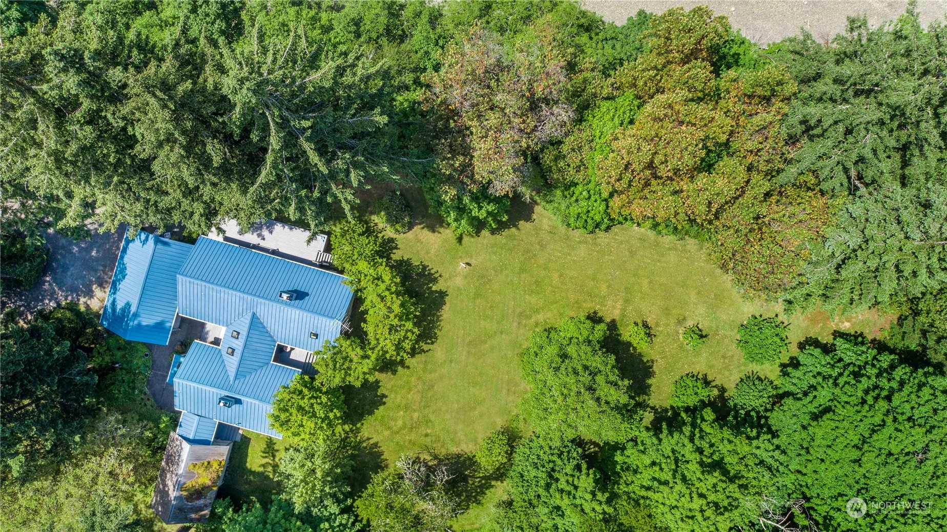 8615 Higgins Cove Road Anderson Island, WA 98303 - Photo 39 of 40 an aerial view of residential house with an outdoor space and trees all around