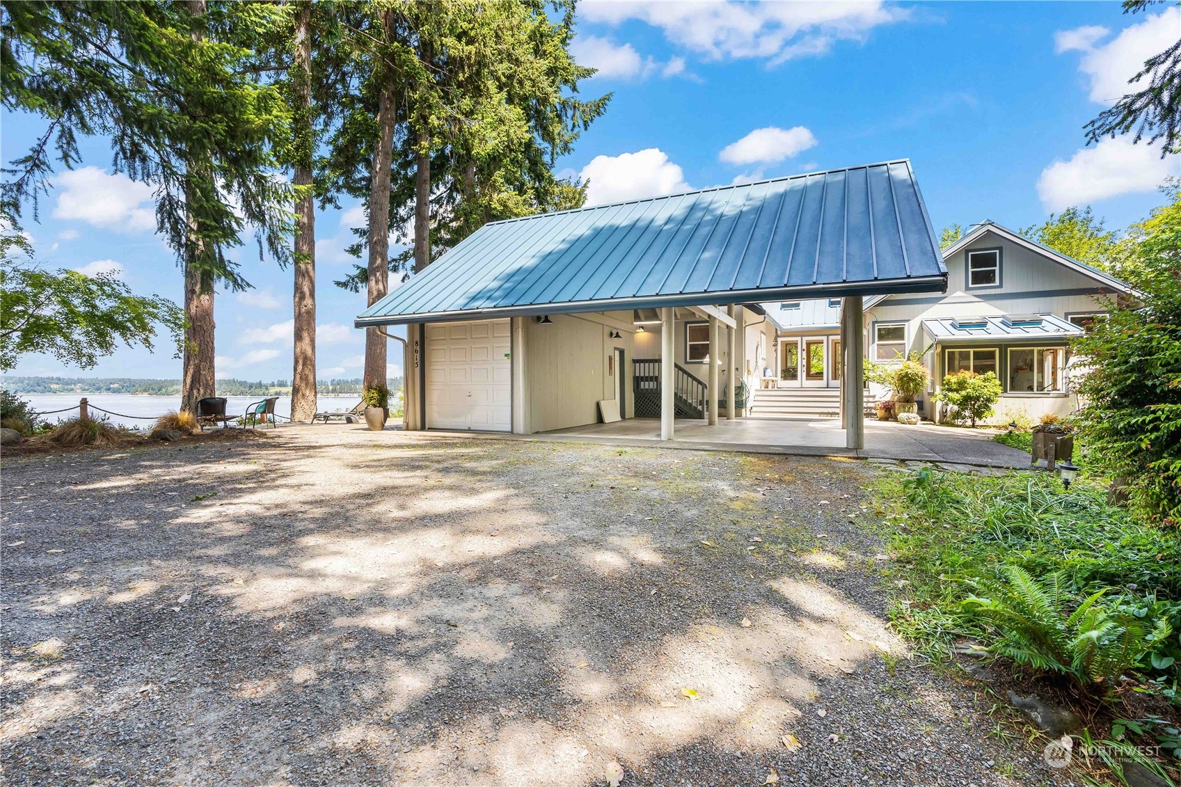 8615 Higgins Cove Road Anderson Island, WA 98303 - Photo 6 of 40 a front view of a house with a yard