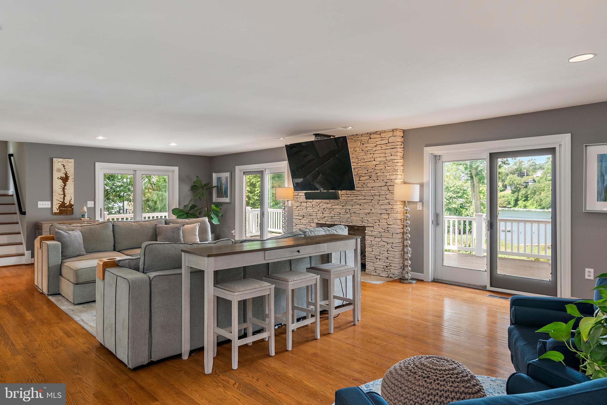 812 Coachway Annapolis, MD 21401 - Photo 15 of 75 a living room with furniture a flat screen tv and a floor to ceiling window