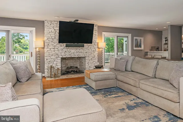 a living room with furniture a rug and a chandelier