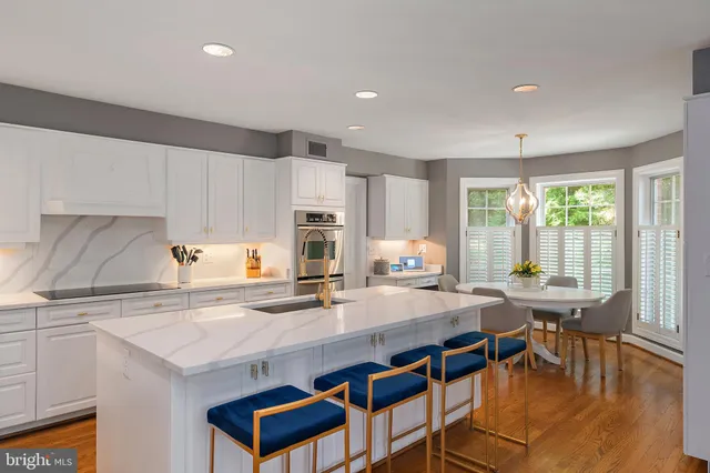 a kitchen with stainless steel appliances a sink a stove and a refrigerator