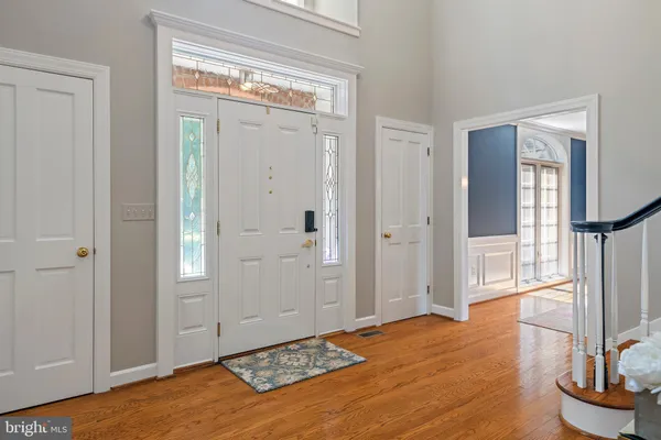 a view of entryway with wooden floor and stairs