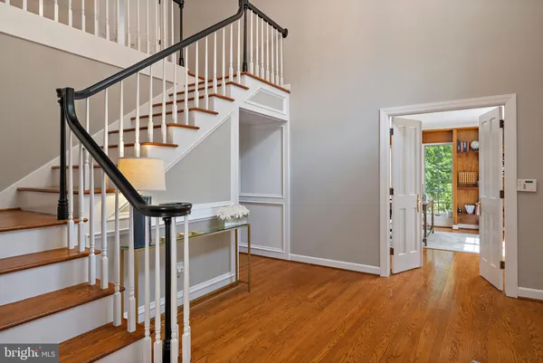 a view of entryway and hall with wooden floor