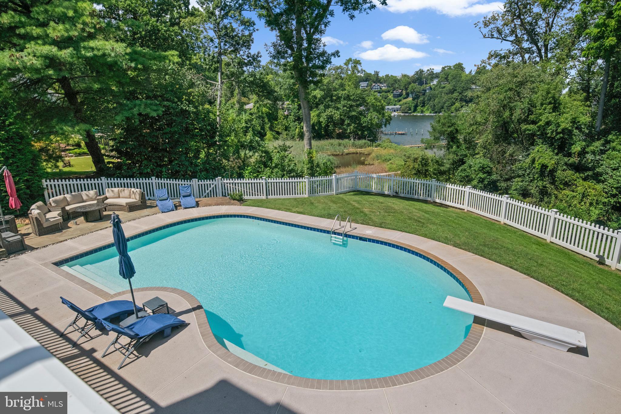 812 Coachway Annapolis, MD 21401 - Photo 65 of 75 a view of a swimming pool with lawn chairs under an umbrella